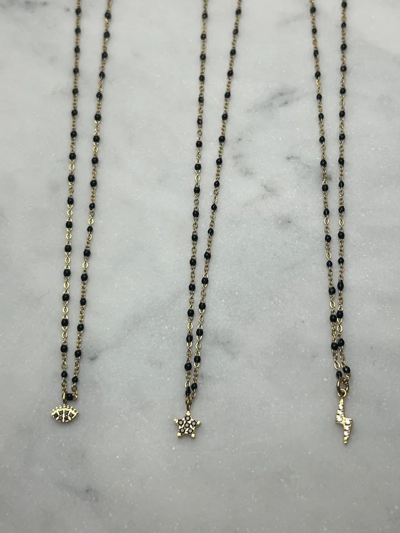 Collier Mona noir (trèfle, croix, oeil, étoile, éclair)